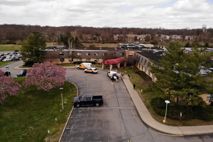 Ambulance crews are parked outside Andover Subacute and Rehabilitation Center in Andover, N.J., on . Police responding to an anonymous tip found more than a dozen bodies Sunday and Monday at the nursing home in northwestern New Jersey, according to news reports